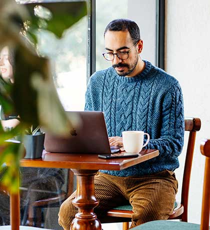 Man at coffee shop on laptop